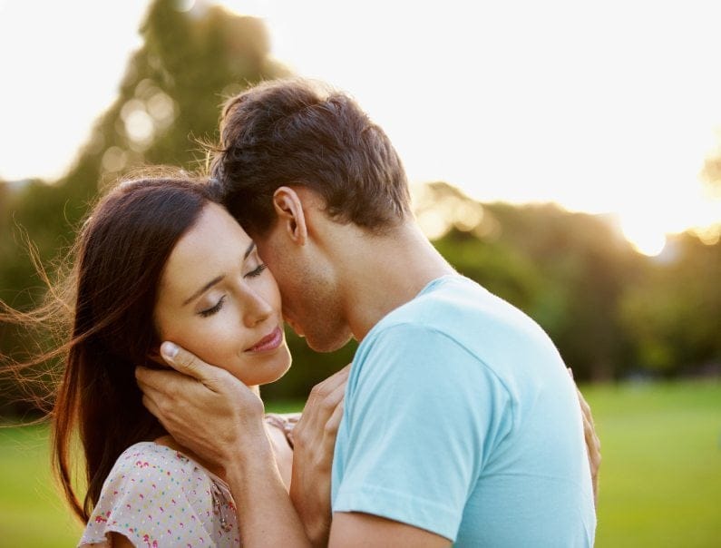 Young adult couple hugging