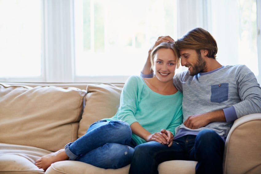 couple couch cuddle happy