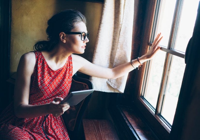 Hipster woman looking out window