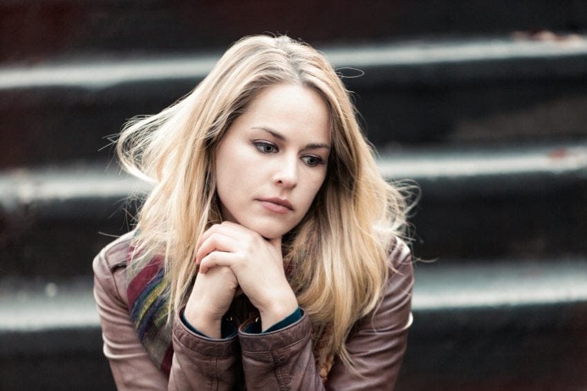 Sad looking woman on steps