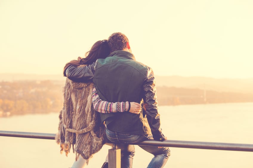 Couple sitting on a railing