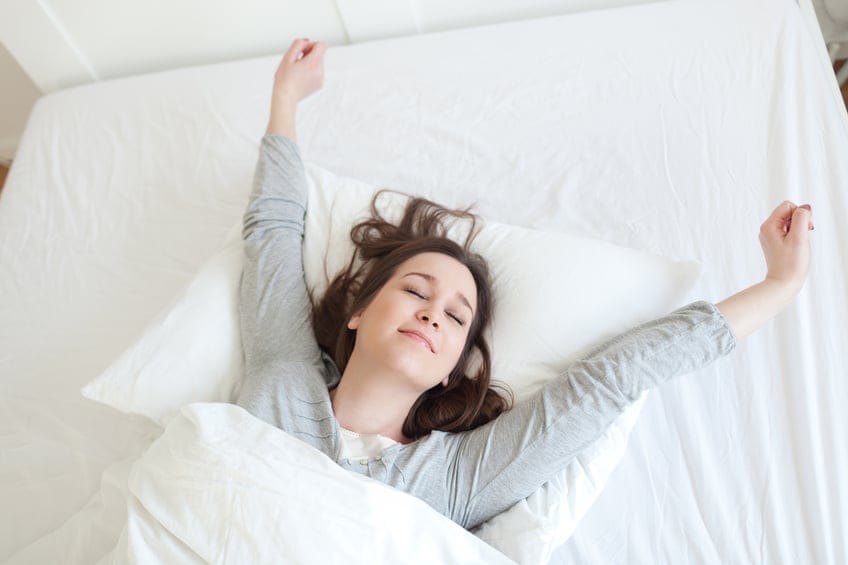 Woman waking up rested.