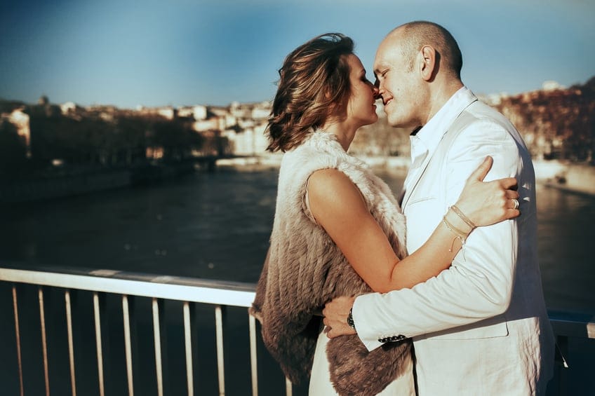 Couple kissing on a bridge