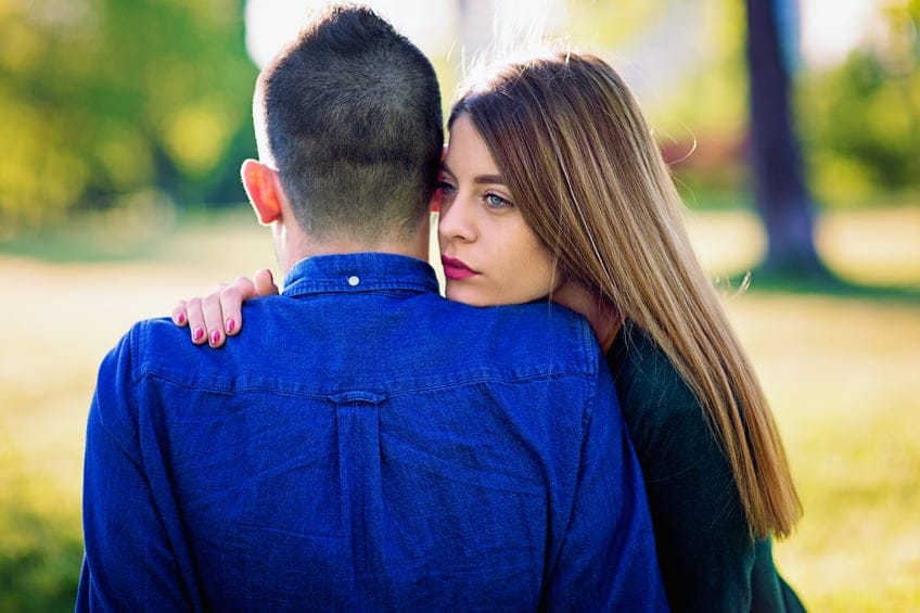 Young couple is standing in the park.