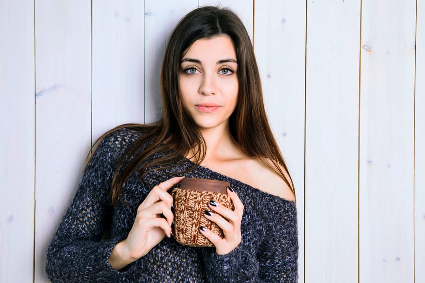 The girl with a wooden cup in his hands