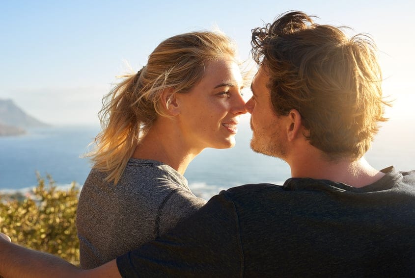 Couple sat near ocean