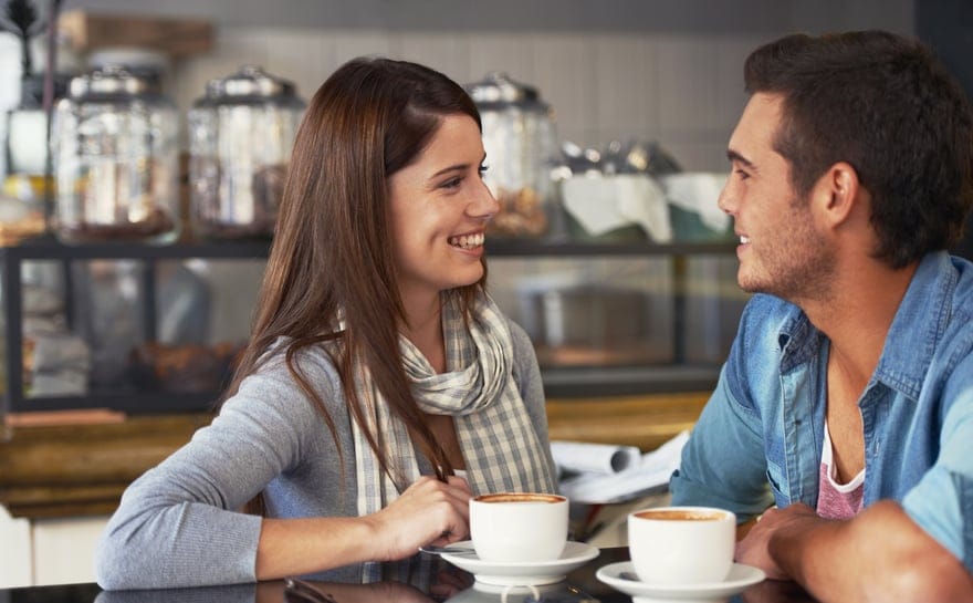 Couple flirting while drinking coffee