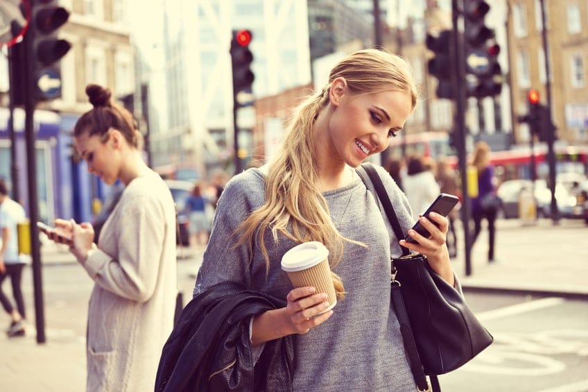 Smiling young woman standing on the street
