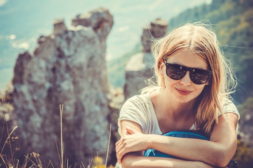 Woman Traveler hiking in Mountains