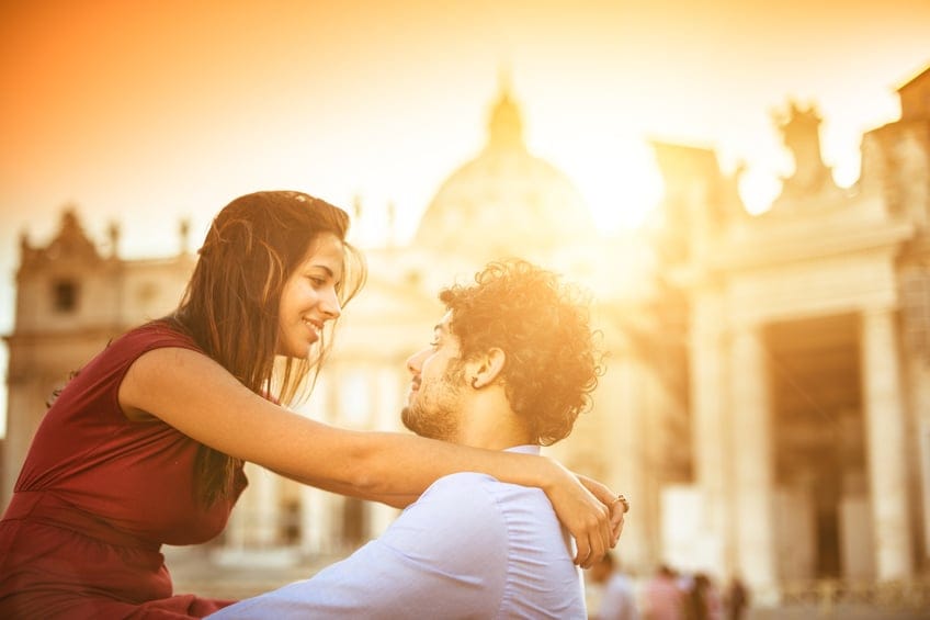 Tourists embracing at sunset