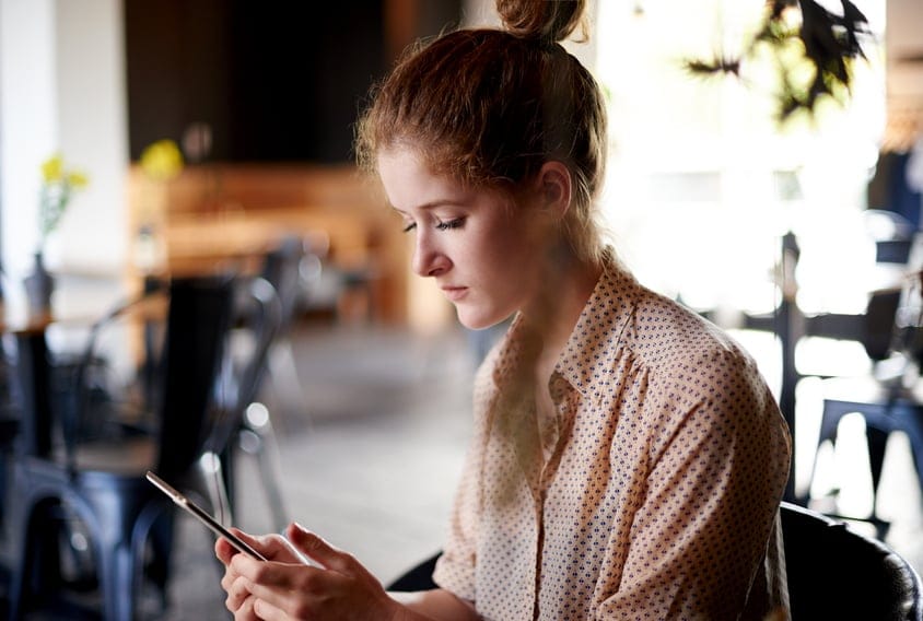 Young ginger girl smartphone