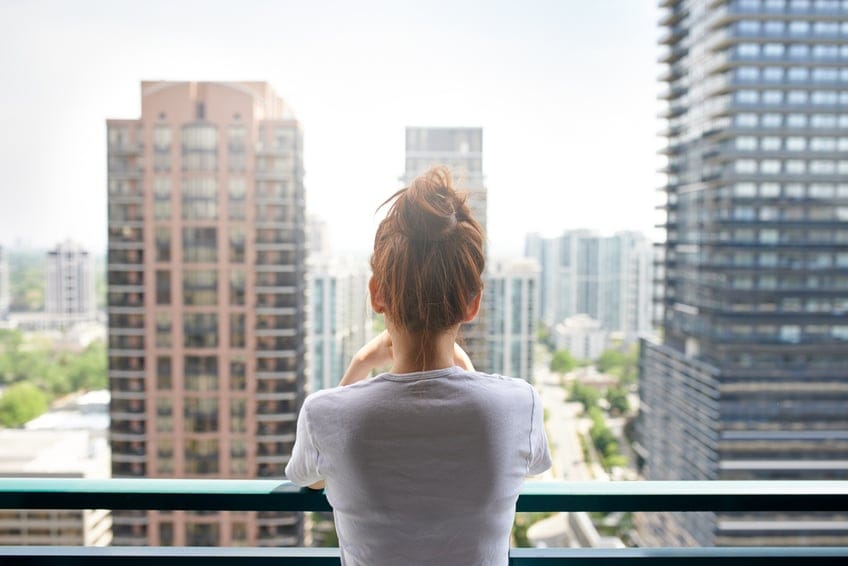 woman alone balcony city view