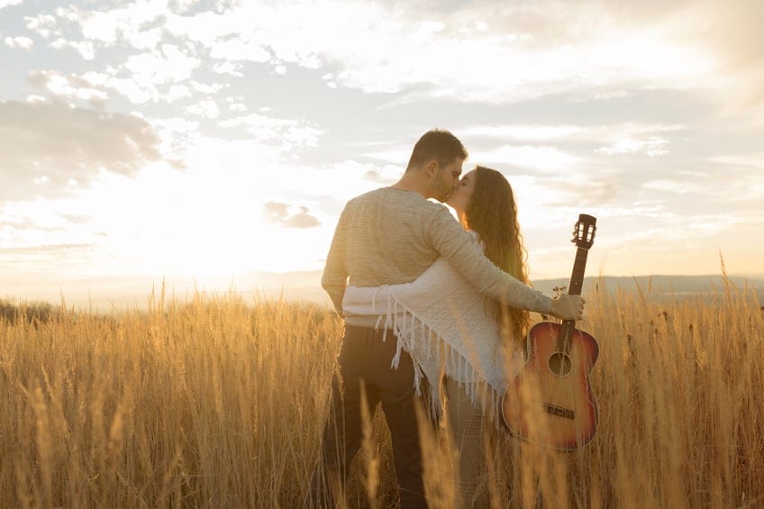 Couple kissing in a field