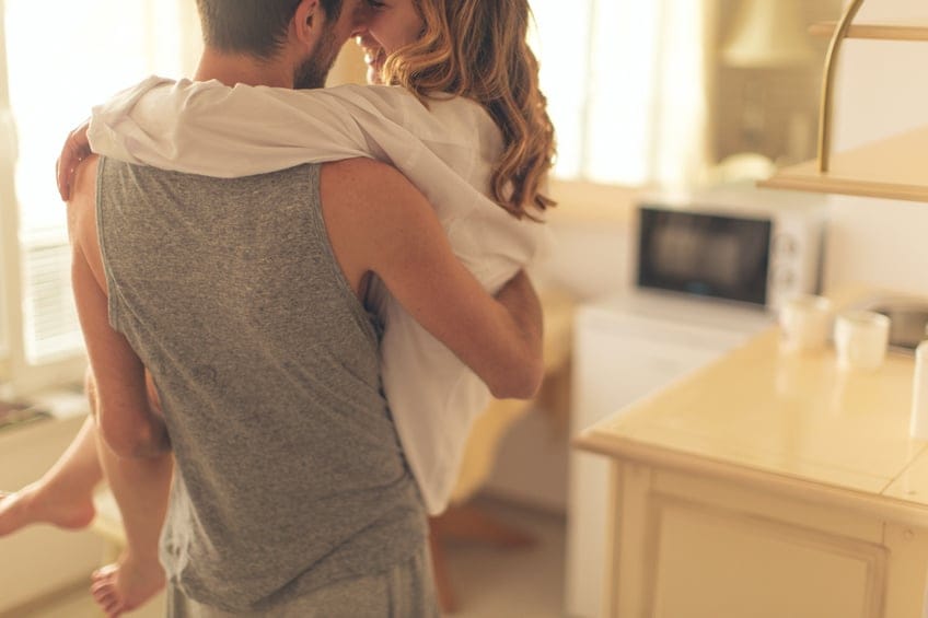 Loving couple carrying kitchen