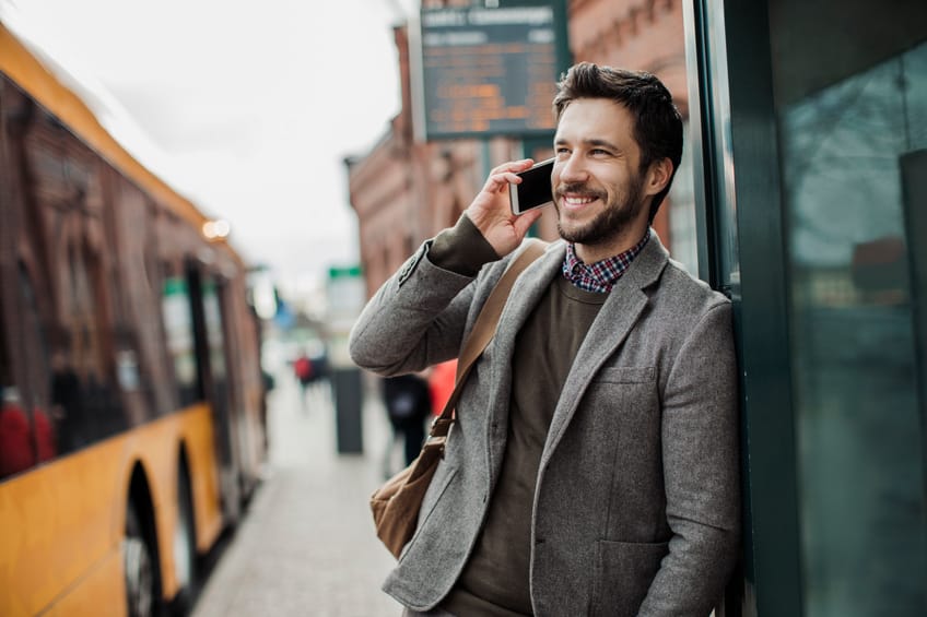 Businessman on the phone at bus station