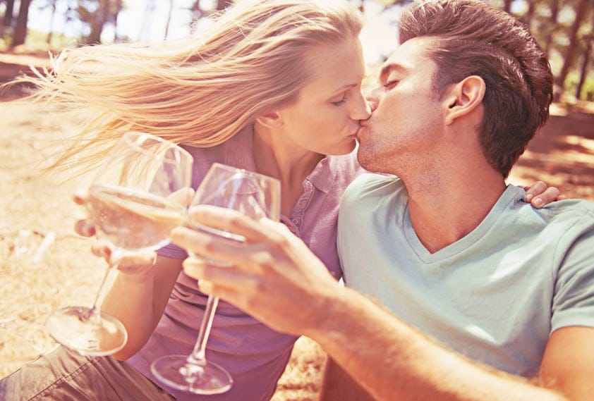 Couple kissing wine