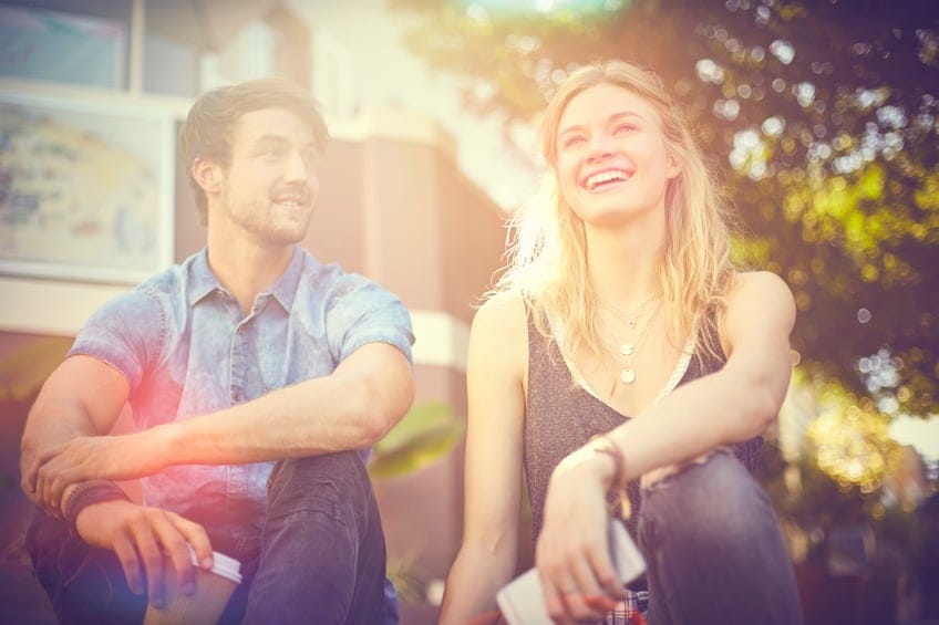 Happy couple sitting outdoors