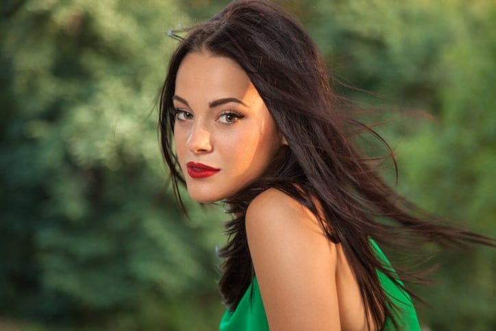 beautiful brunette lady in green