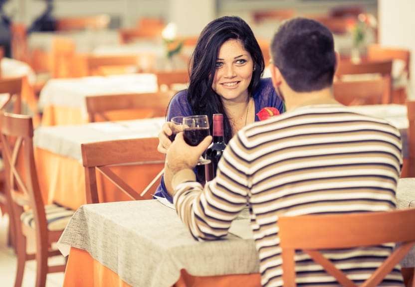 Young couple toasting wine at the restaurant