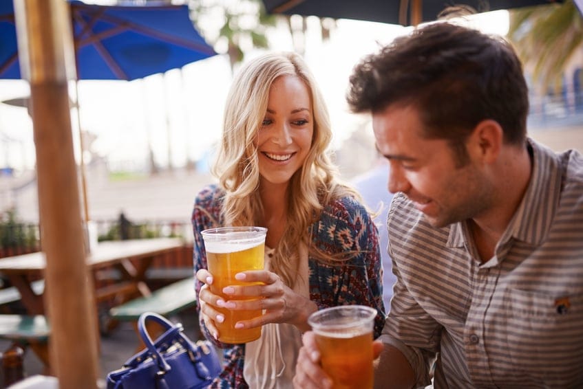 Couple drinking beer at outdoor.