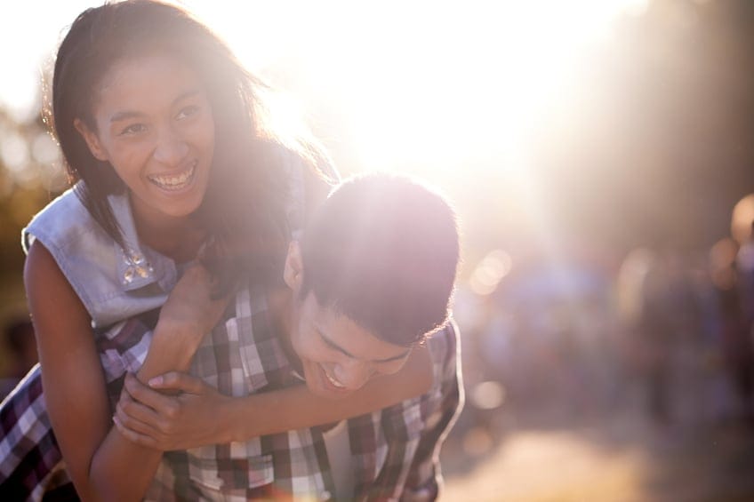 couple embracing sunshine summer