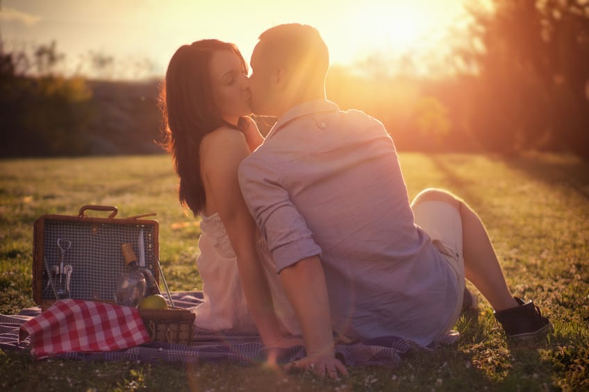 Attractive Couple Enjoying Romantic Sunset Picnic in the Countryside