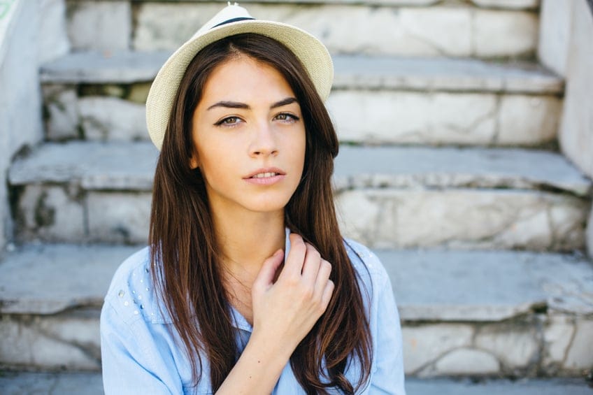 Young beautiful female sitting on the ruined stairs