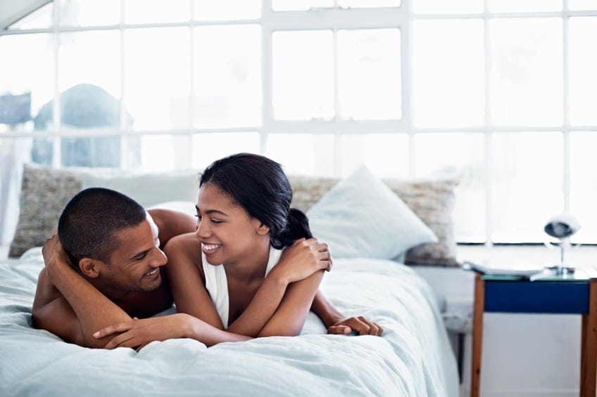 couple bed happy smiling