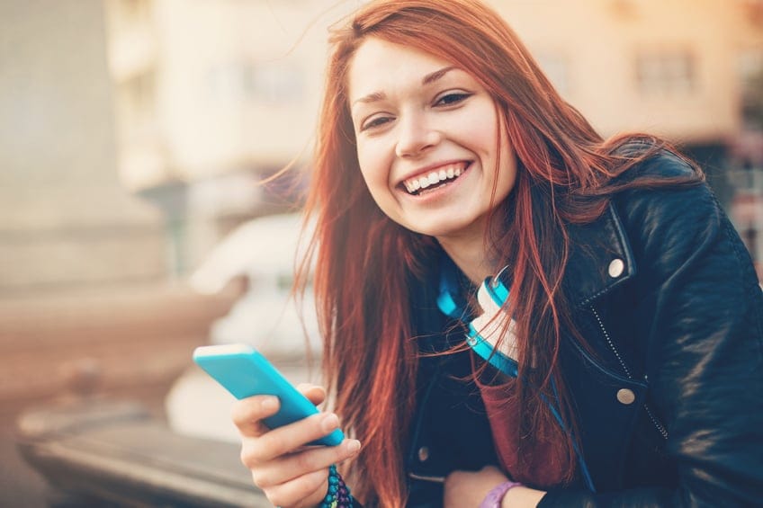 woman happy texting phone smiling