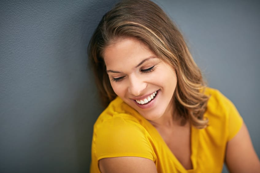 Smiling brunette yellow top