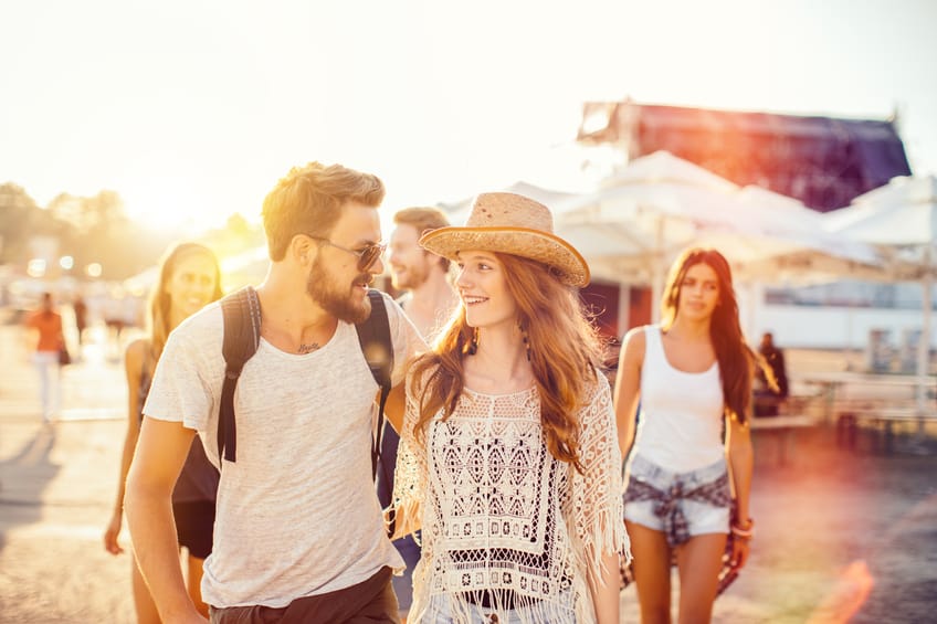 Couple enjoying an outdoor concert at sunset.