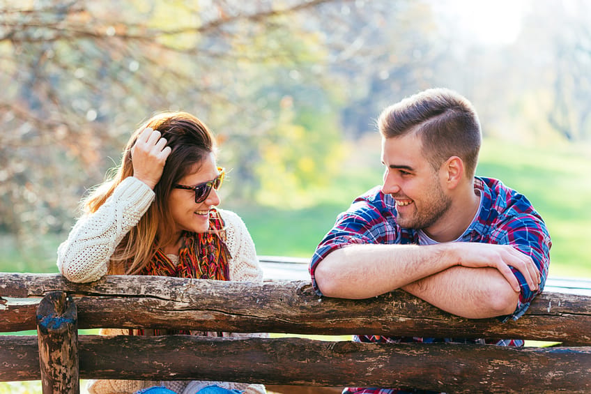 Romantic attractive couple hugging and loving in city park