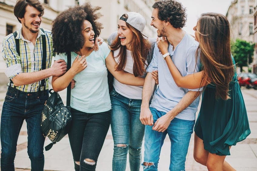 Group of mixed race people outdoors in the city, having a great time.