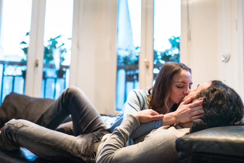 French couple kissing and flirting on the couch