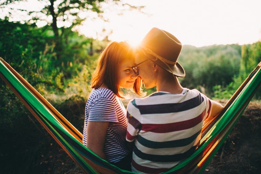 couple romance hammock outdoors sunset