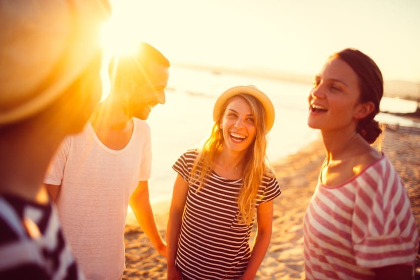 couple beach friends party sunset
