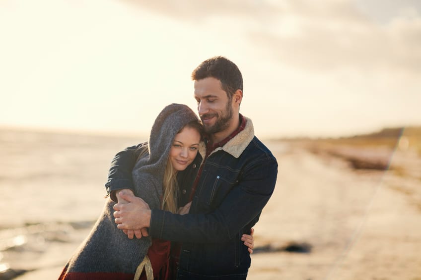 Photo of a lovely couple walking on the beach