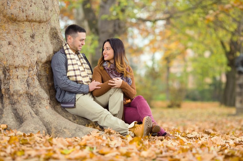 Happy Couple beneath the Tree in a Park