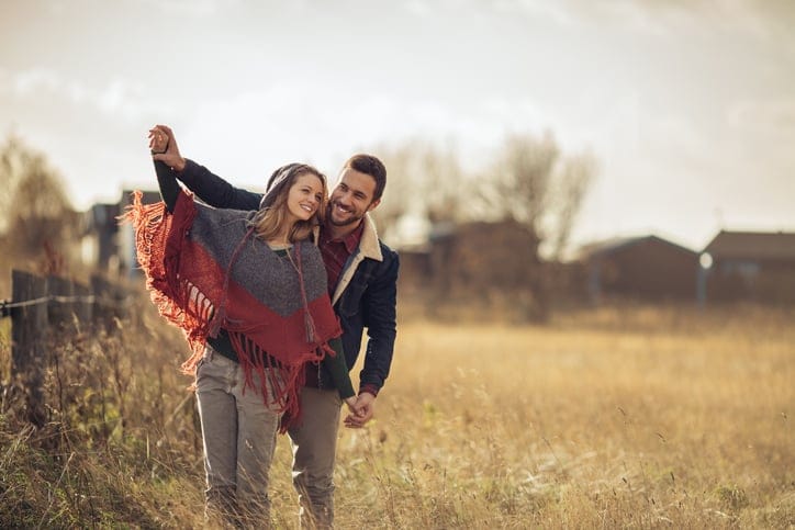 Photo of a happy couple enjoying countryside together