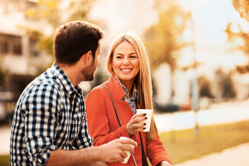Young happy couple is enjoying in the park.