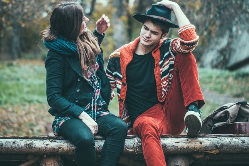 Young hipster couple, boyfriend and a girlfriend enjoying the cold weather outside of the house.