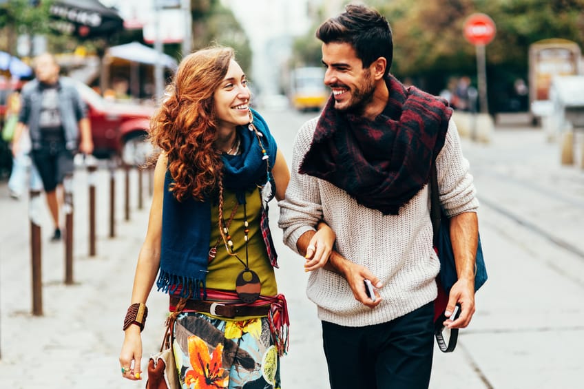 Happy couple holding hands and taking a walk.