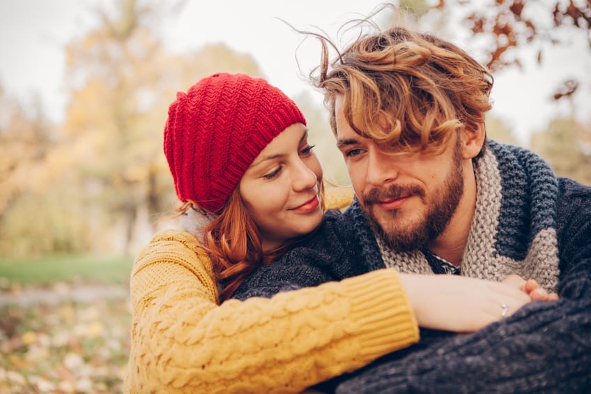 Young couple enjoying in park in autumn.