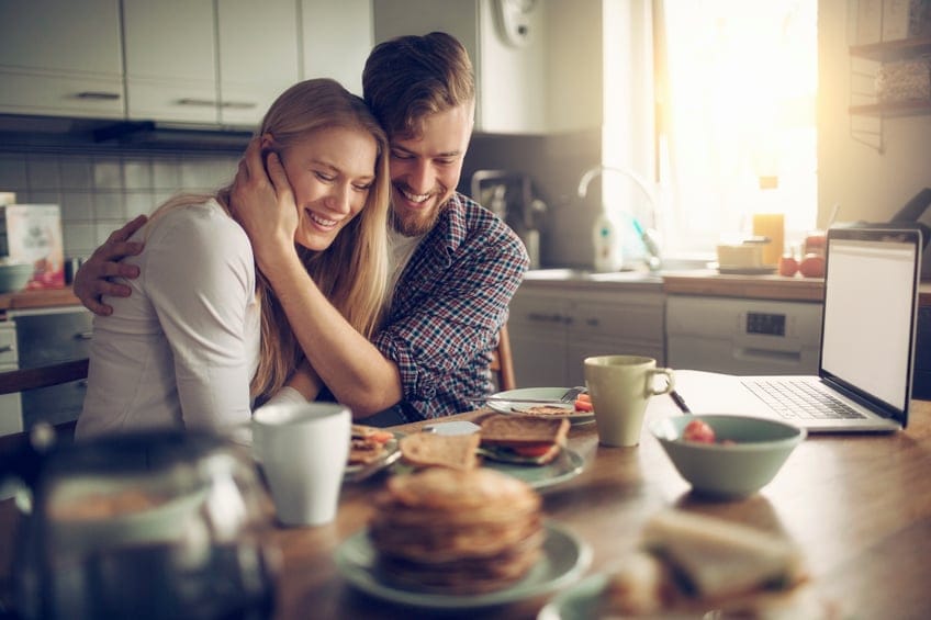 Photo of a young couple enjoying breakfast together