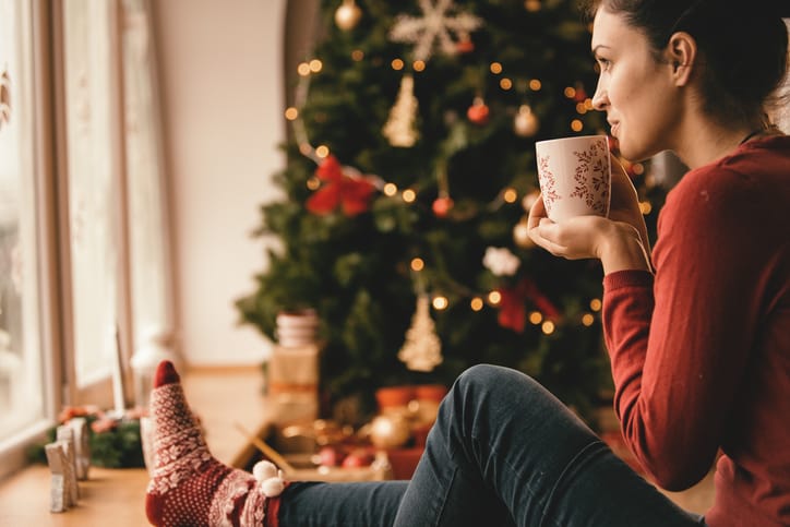 Young woman spending Christmas holiday at home.