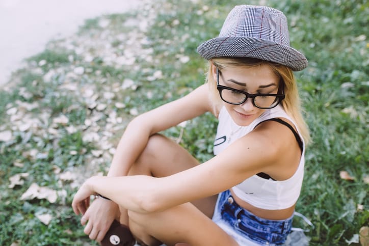 young woman hipster grass park portrait
