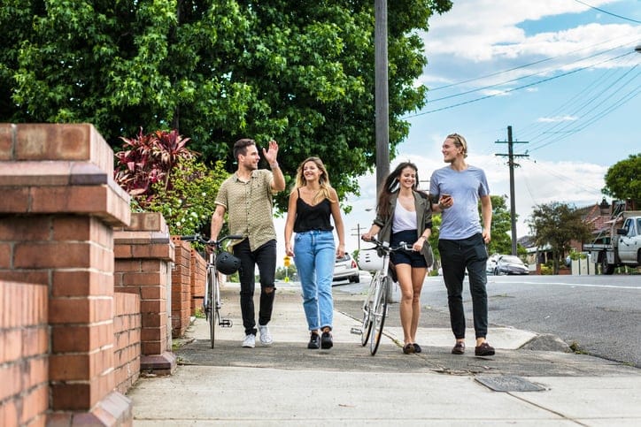 young friends walking outdoors summer