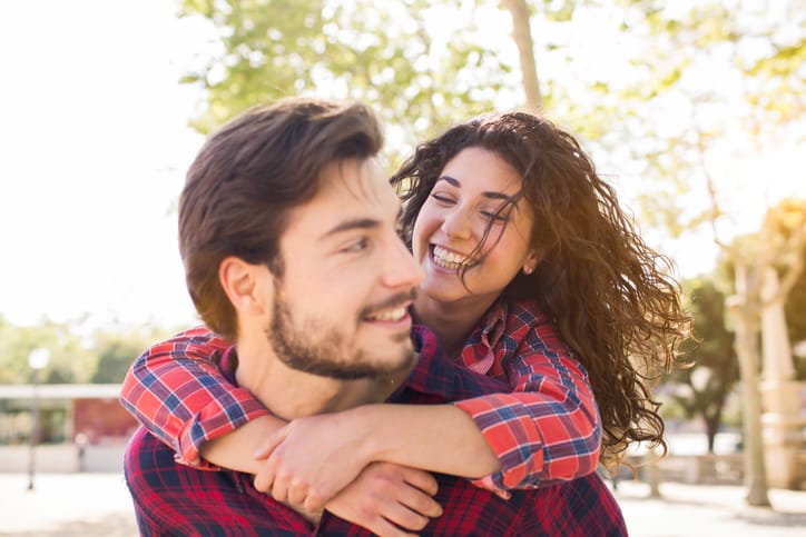 young couple embrace outdoors romance love