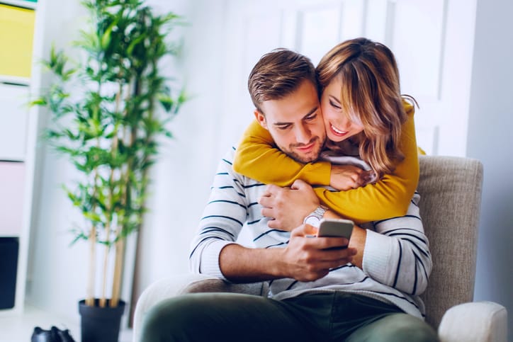young couple close cuddle home