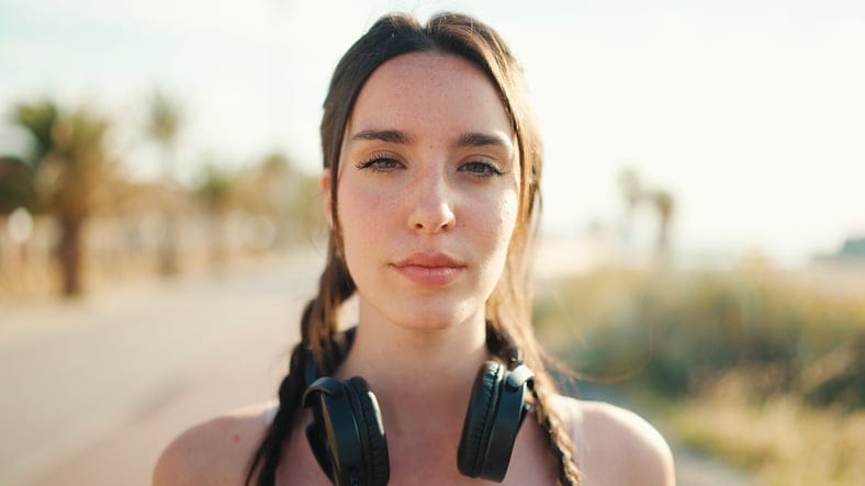 brunette wearing headset around neck